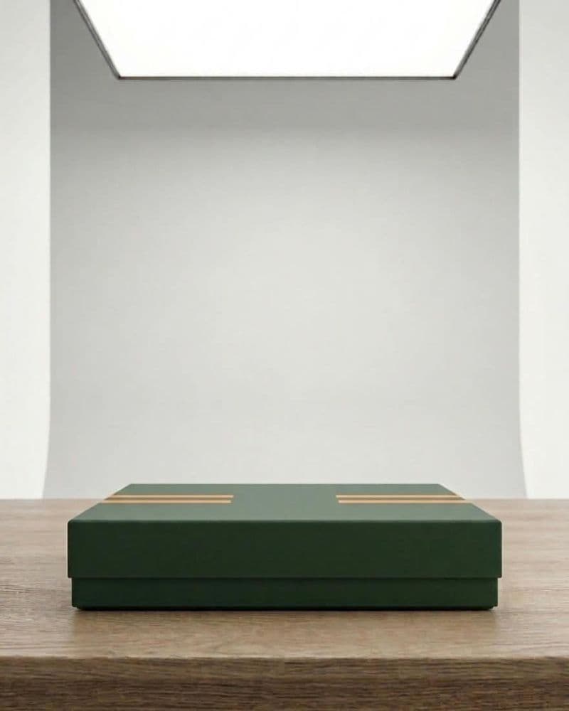 Forest green gift box with gold stripe detail